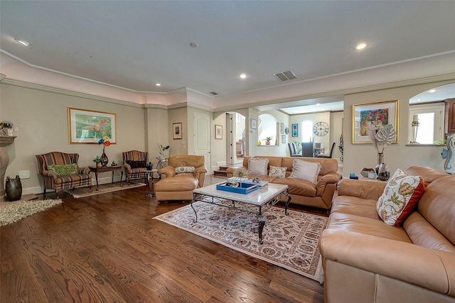 living room with hardwood / wood-style flooring and ornamental molding