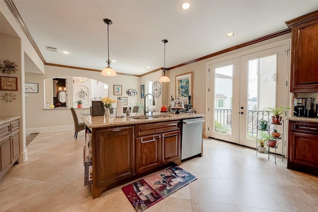 kitchen with pendant lighting, sink, dishwasher, light stone countertops, and french doors