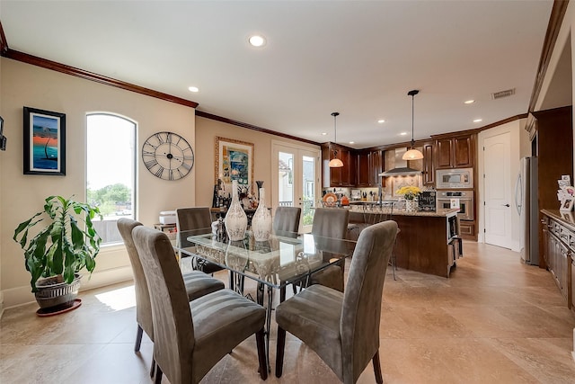 dining area with crown molding, french doors, and a healthy amount of sunlight