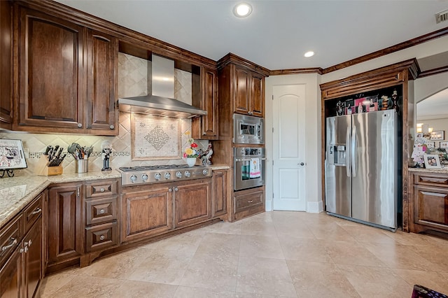 kitchen with wall chimney range hood, appliances with stainless steel finishes, tasteful backsplash, ornamental molding, and light stone countertops