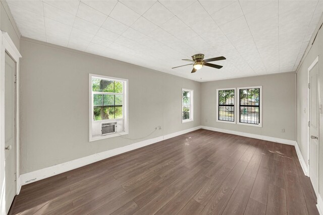 unfurnished room featuring plenty of natural light, crown molding, and hardwood / wood-style flooring