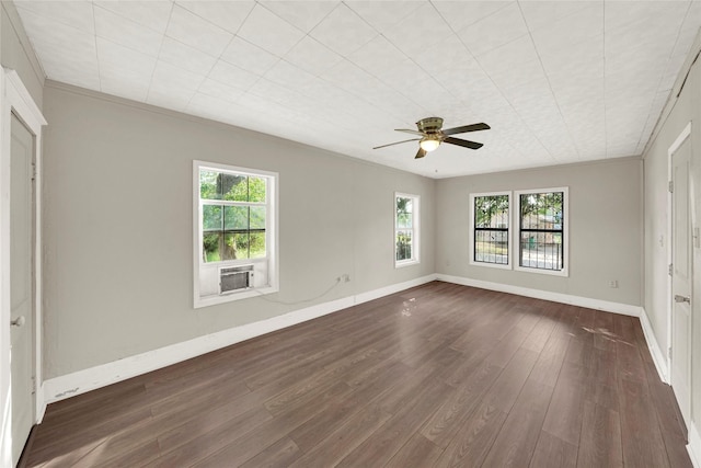 empty room featuring crown molding, dark hardwood / wood-style floors, cooling unit, and ceiling fan