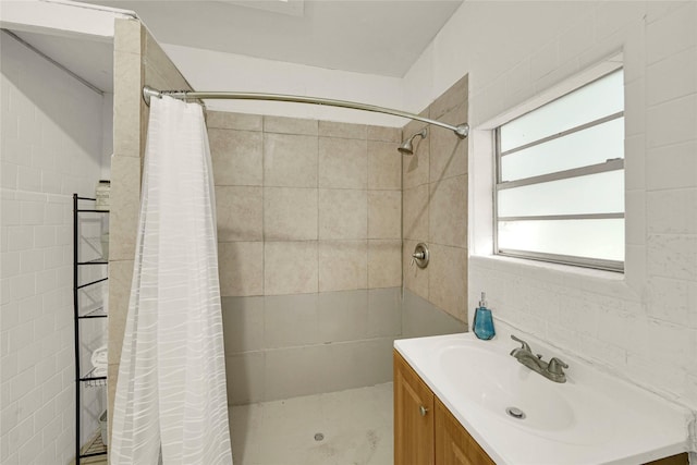 bathroom featuring vanity, a shower with shower curtain, and tile walls