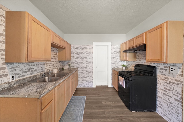 kitchen with dark wood-type flooring, light brown cabinets, black gas range, and a textured ceiling