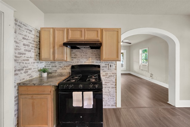 kitchen with black gas stove, ceiling fan, light brown cabinetry, a textured ceiling, and dark wood-type flooring