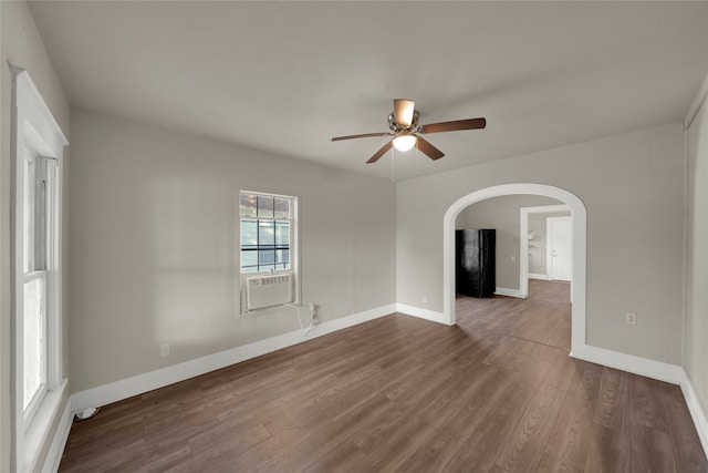 empty room featuring hardwood / wood-style flooring, cooling unit, and ceiling fan