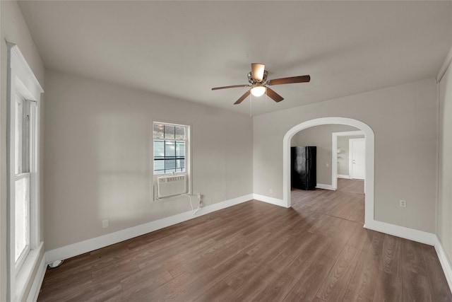 unfurnished room featuring dark wood-type flooring, cooling unit, and ceiling fan