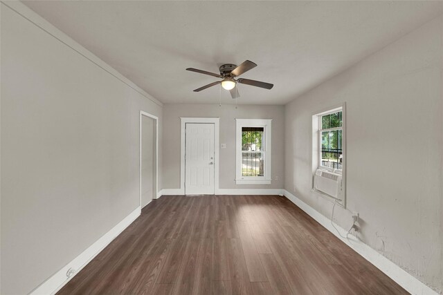 unfurnished room with wood-type flooring, ceiling fan, and cooling unit