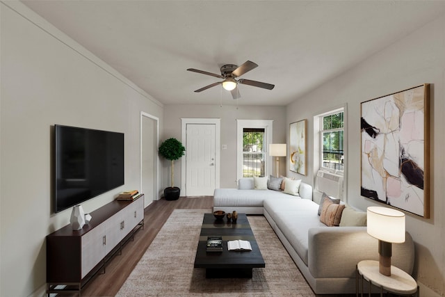 living room featuring dark wood-type flooring and ceiling fan