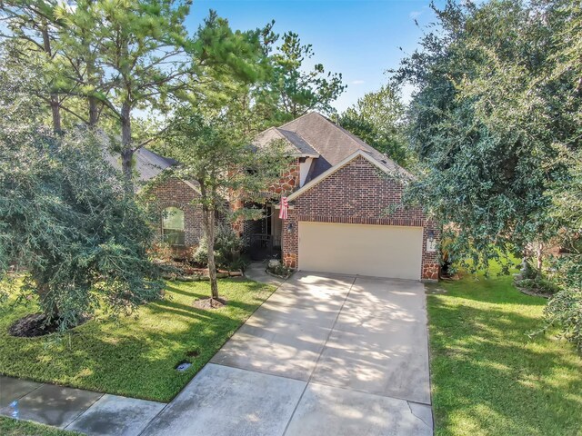 view of front of property with a front yard and a garage