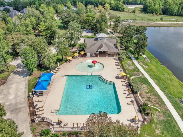 view of pool with a water view and a patio area