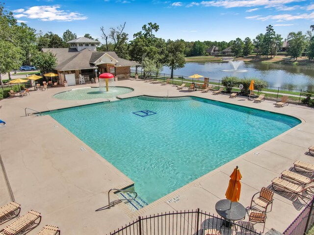 view of pool featuring a water view, a patio area, and pool water feature