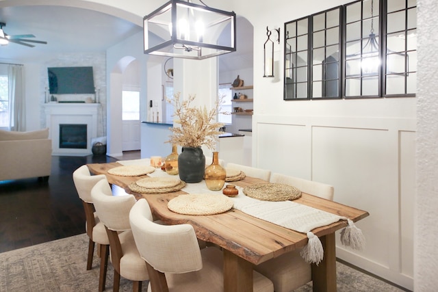 dining room featuring hardwood / wood-style floors and ceiling fan with notable chandelier