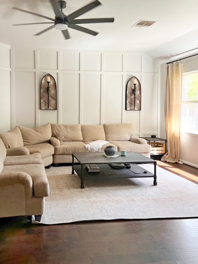 living room featuring hardwood / wood-style floors, vaulted ceiling, and ceiling fan