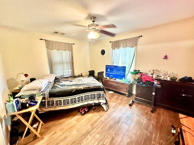 bedroom with ceiling fan and wood-type flooring