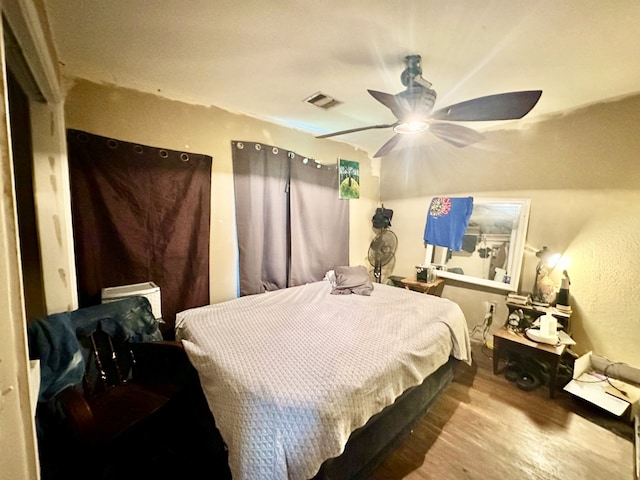 bedroom with hardwood / wood-style flooring and ceiling fan