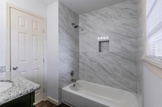 bathroom with vanity and tiled shower / bath combo