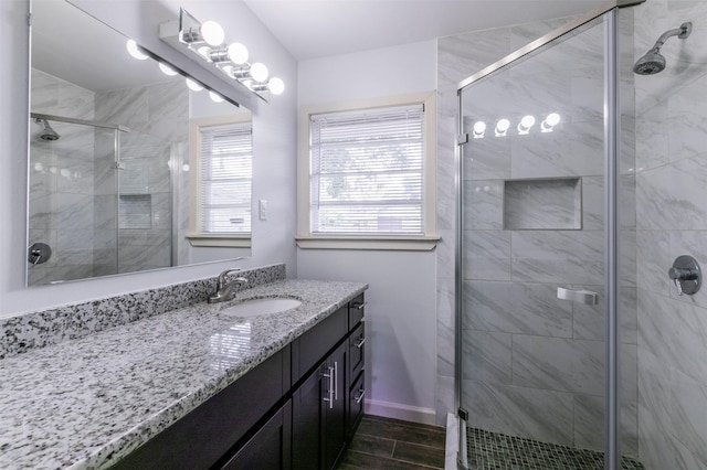 bathroom featuring vanity and a shower with shower door