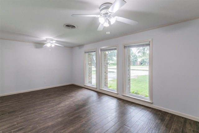 spare room featuring dark hardwood / wood-style floors, ceiling fan, and ornamental molding