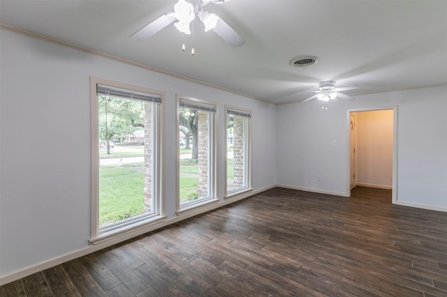 spare room featuring dark hardwood / wood-style flooring, ceiling fan, and ornamental molding