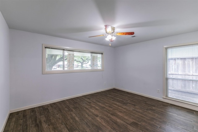 spare room featuring ceiling fan and dark hardwood / wood-style floors