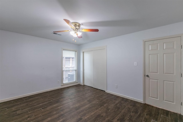 unfurnished bedroom featuring ceiling fan and dark hardwood / wood-style flooring