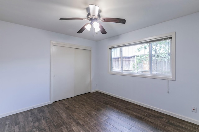 unfurnished bedroom featuring a closet, ceiling fan, and dark wood-type flooring