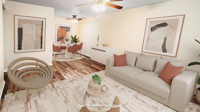 living room featuring hardwood / wood-style floors and ceiling fan