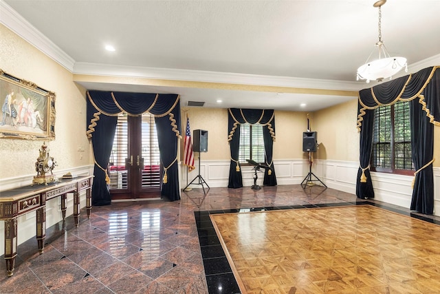 exercise room with plenty of natural light, ornamental molding, and french doors