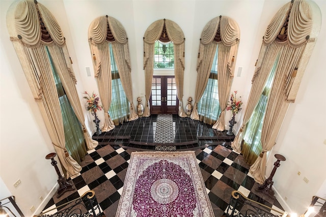 foyer featuring a high ceiling and french doors