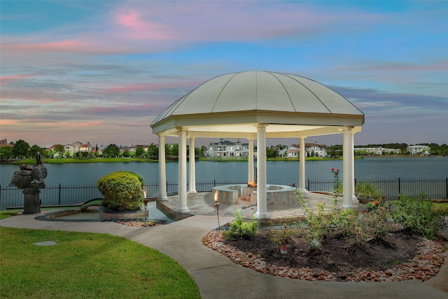 surrounding community featuring a patio area, a gazebo, and a water view