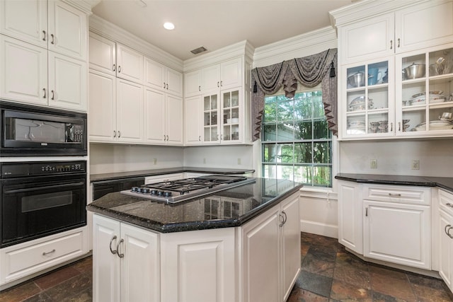 kitchen with black appliances, a kitchen island, and white cabinets