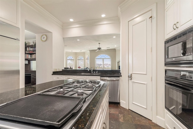 kitchen with ceiling fan, sink, white cabinetry, dark stone countertops, and black appliances