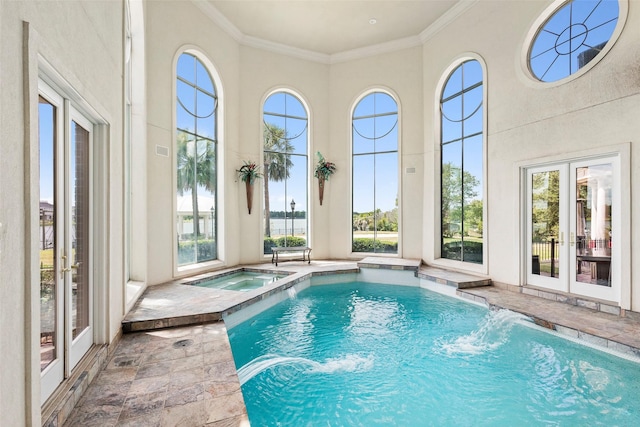 view of pool featuring an in ground hot tub, pool water feature, and french doors