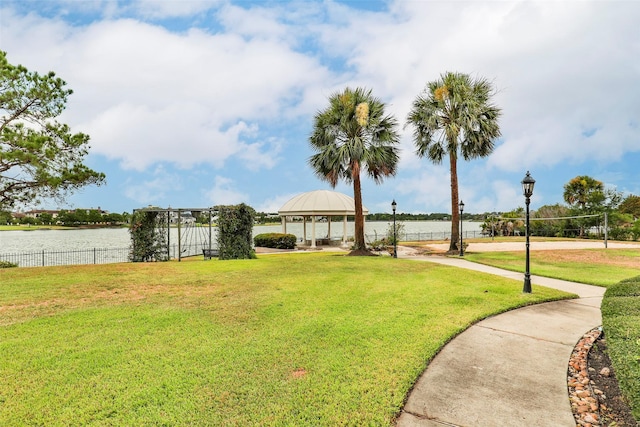 view of yard with a water view, a gazebo, and volleyball court