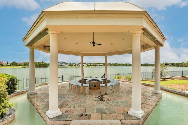 view of patio with a gazebo, a water view, and ceiling fan