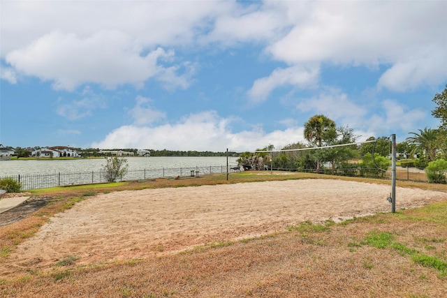 view of home's community with a water view and volleyball court