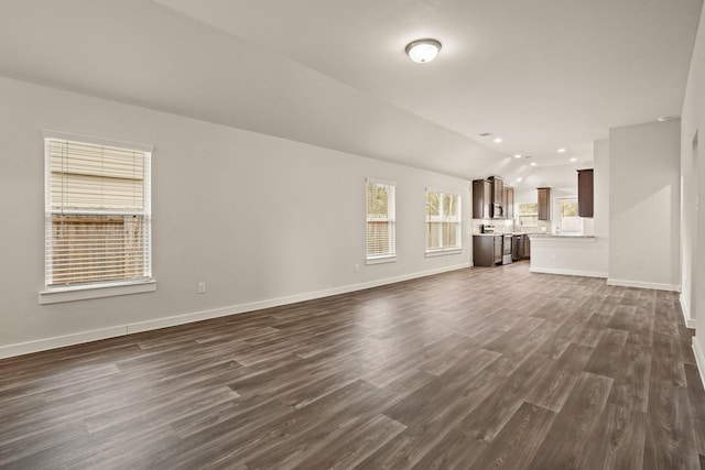 unfurnished living room with dark wood-type flooring and lofted ceiling