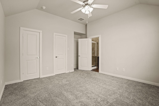 unfurnished bedroom with ensuite bathroom, lofted ceiling, carpet, and ceiling fan