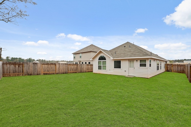 back of house featuring a lawn