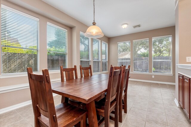 dining area featuring light tile patterned floors, visible vents, and baseboards