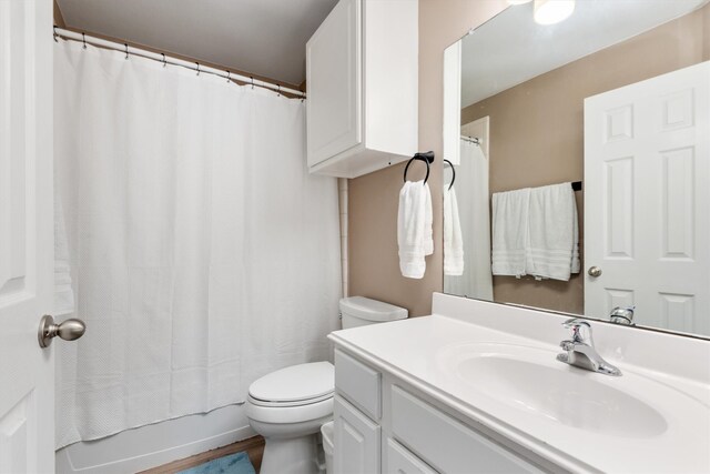 bathroom with vanity, toilet, and wood finished floors