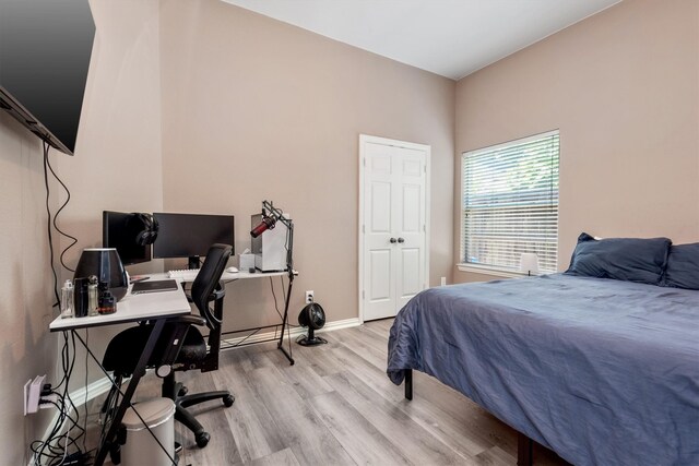 bedroom with baseboards and wood finished floors