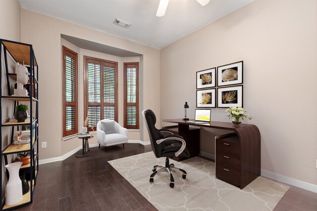 home office with wood finished floors, visible vents, and baseboards