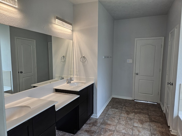 bathroom with a textured ceiling and vanity