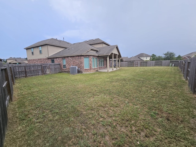 view of yard featuring a patio area and central AC