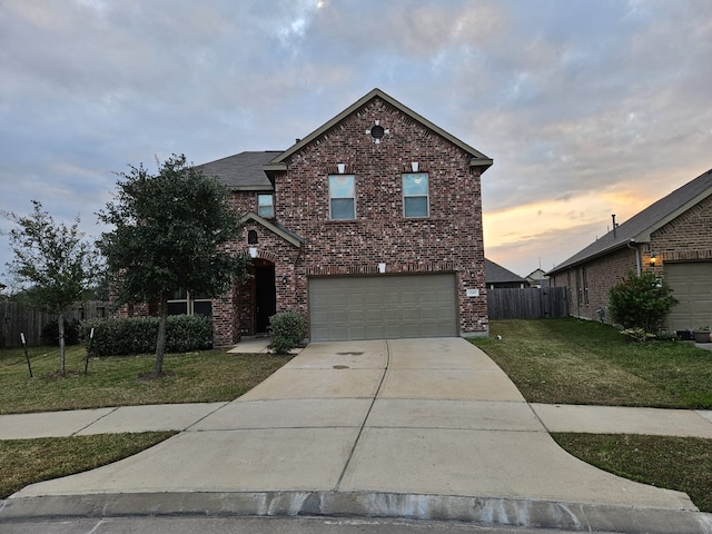 front facade with a yard and a garage