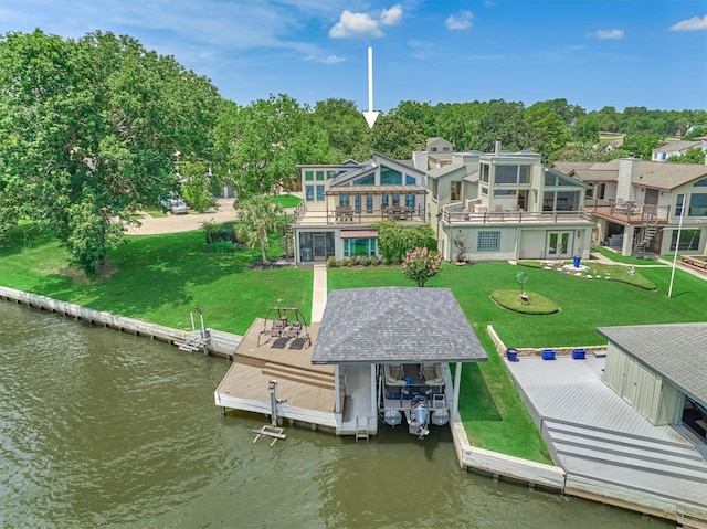 view of dock featuring a balcony, a water view, and a lawn