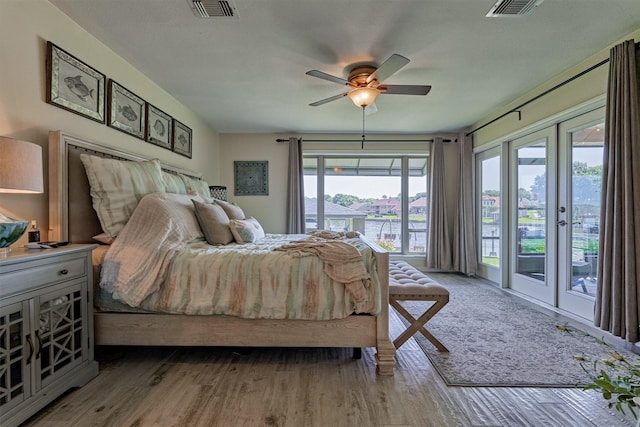 bedroom with ceiling fan, access to exterior, wood-type flooring, and french doors