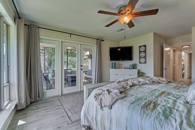 bedroom with access to outside, ceiling fan, light hardwood / wood-style flooring, and french doors